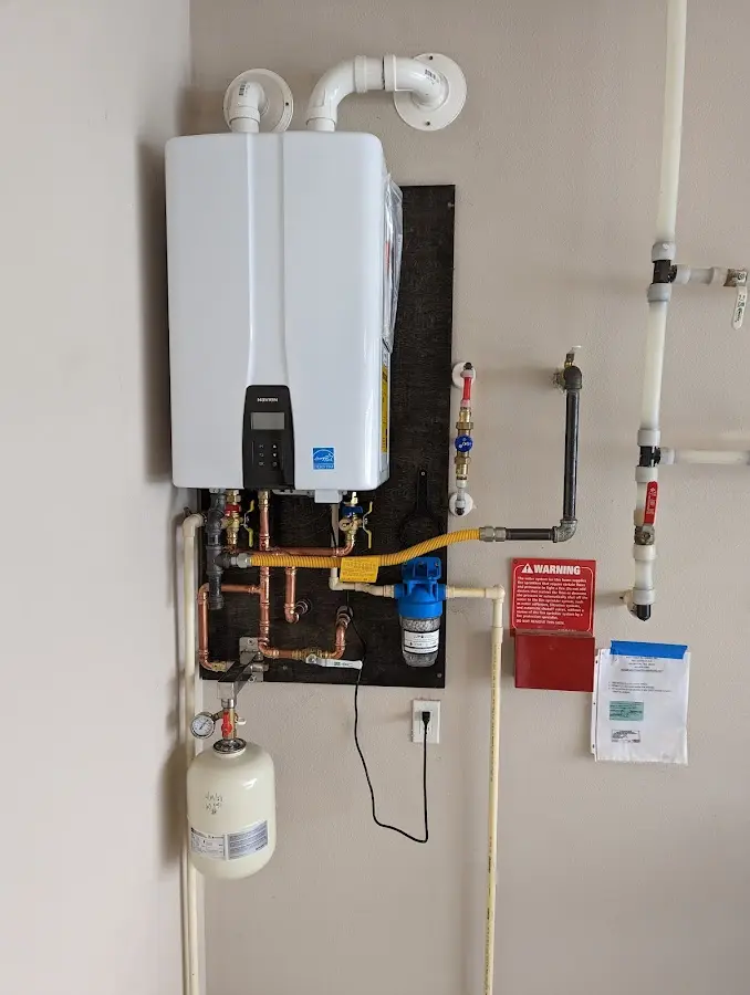 Professional plumber installing copper piping in a Magnolia home